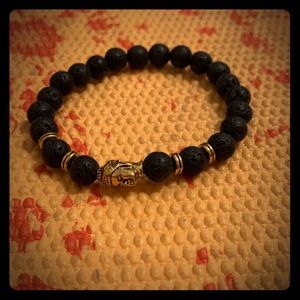 Lava rock bracelet with gold Buddha head detail